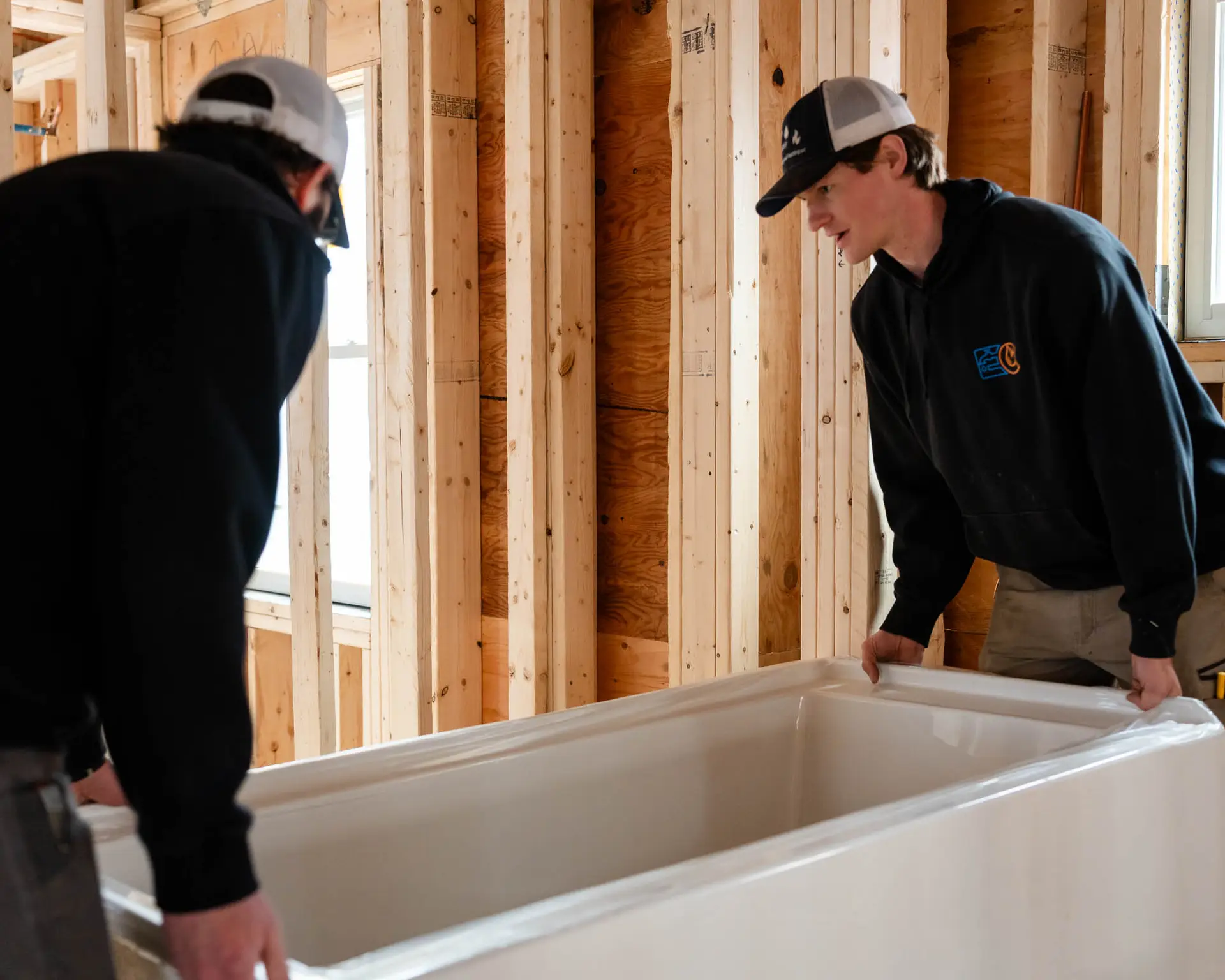 Essex County Plumbing and Heating crew installing freestanding tub during bathroom renovation