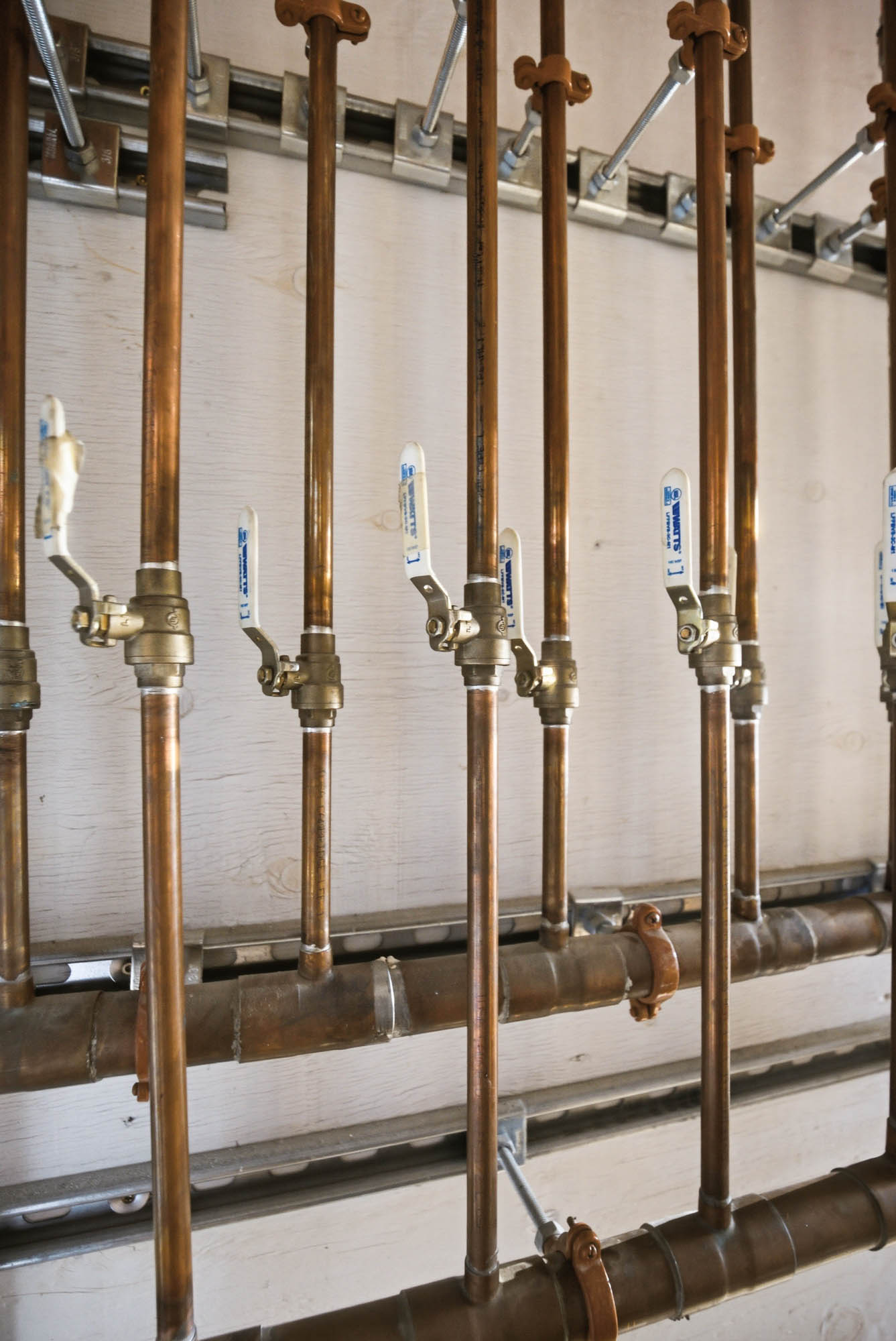 Copper manifold with Watts quarter-turn shutoff valves, organized rack - hydronic heating