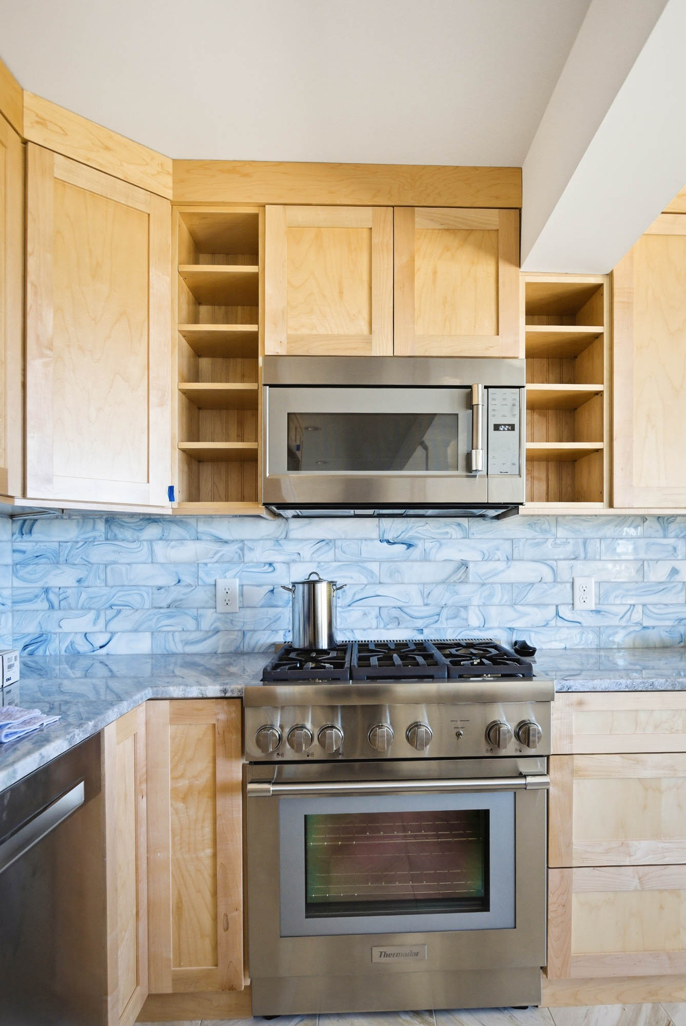 Secondary kitchen with stainless Thermador range, blue marbled subway tile - Ipswich MA plumbing project