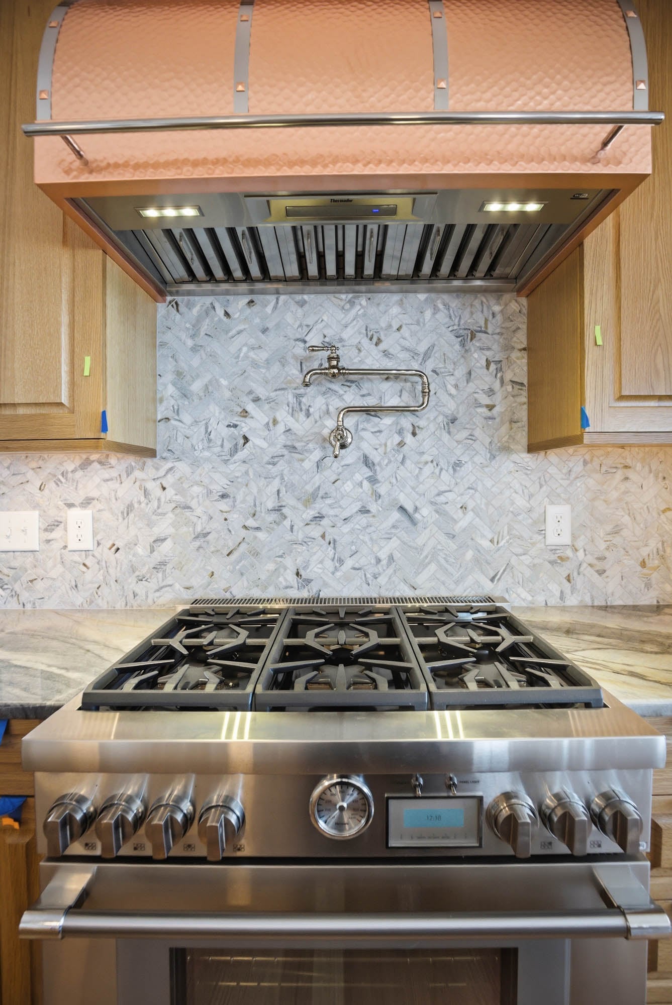 Thermador range with custom copper hood and pot filler, dead-on view - kitchen plumbing