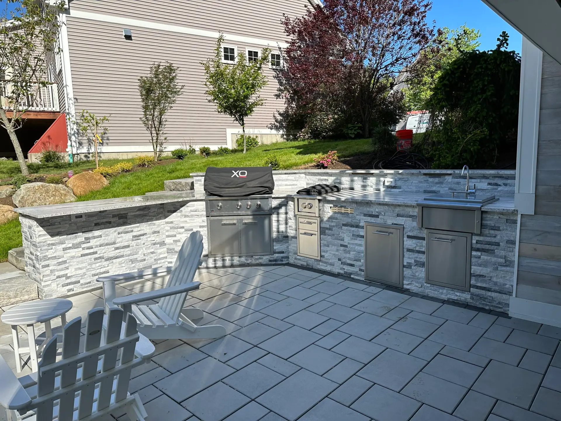 Outdoor kitchen with grill, counters, and bar seating - ECPH gas line installation Essex County MA